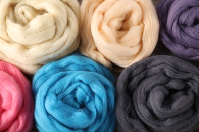 Photo of Colorful felting wool as background, closeup view
