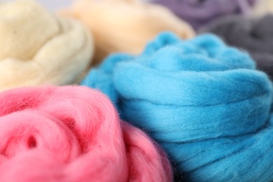 Photo of Colorful felting wool as background, closeup view