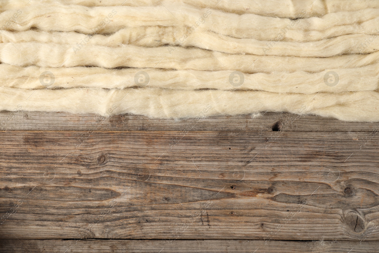 Felting wool on wooden background, top view. Space for text Photo of Felting wool on wooden background, top view. Space for text
