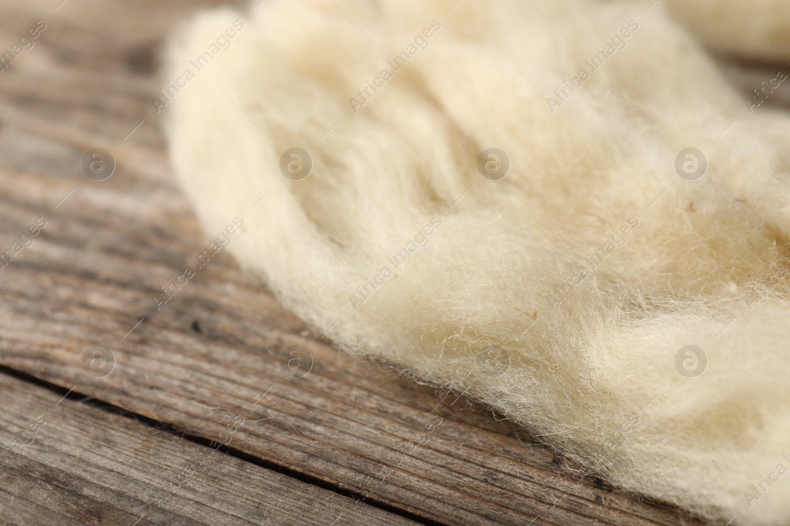 Natural felting wool on wooden background, closeup Photo of Natural felting wool on wooden background, closeup