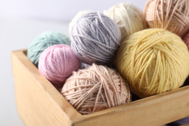 Photo of Colorful knitting yarn on light background, closeup