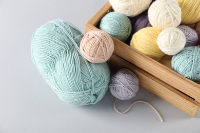 Photo of Colorful knitting yarn on light background, closeup