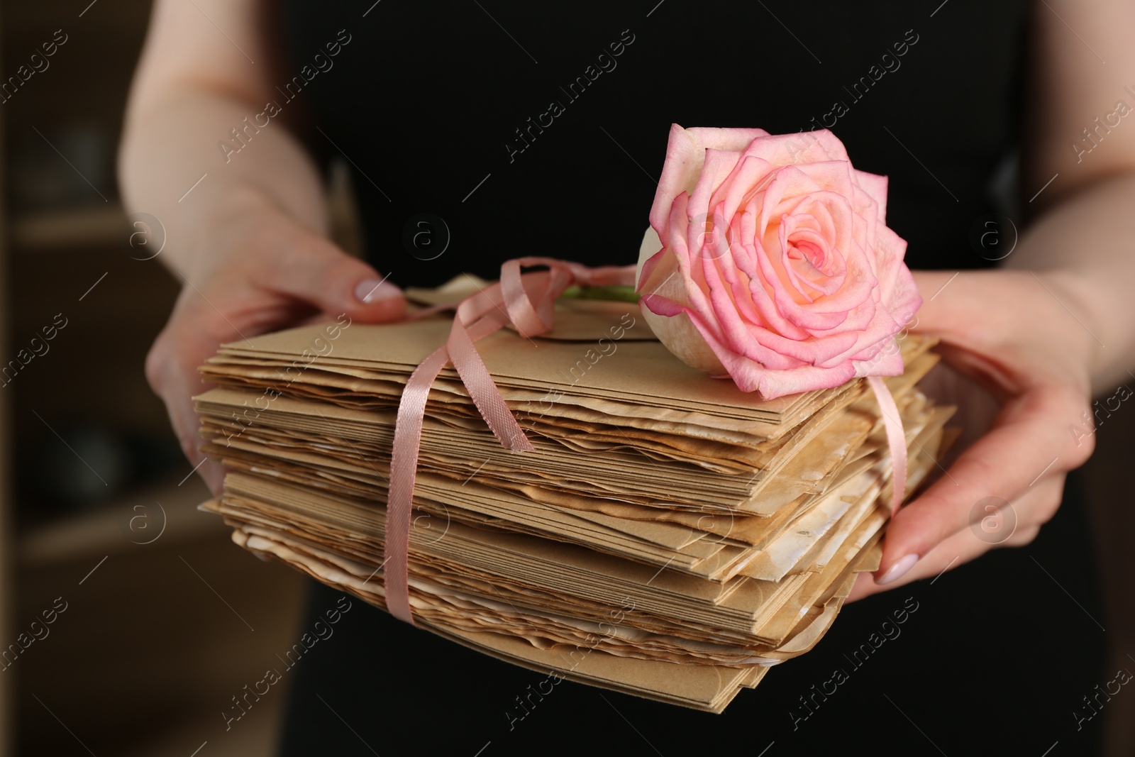 Woman with stack of love letters and rose flower indoors, closeup Photo of Woman with stack of love letters and rose flower indoors, closeup