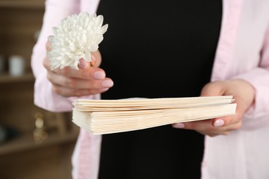Photo of Woman with stack of love letters and flower indoors, closeup