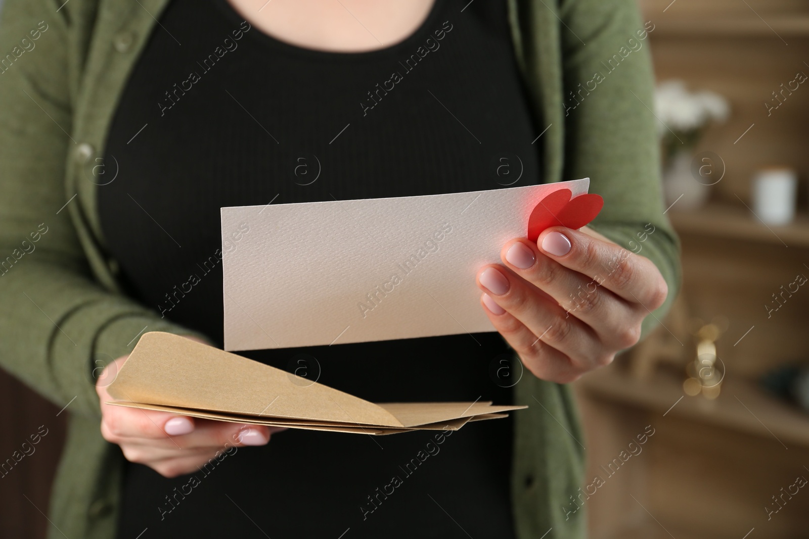 Woman with love letter, envelopes and red heart indoors, closeup Photo of Woman with love letter, envelopes and red heart indoors, closeup