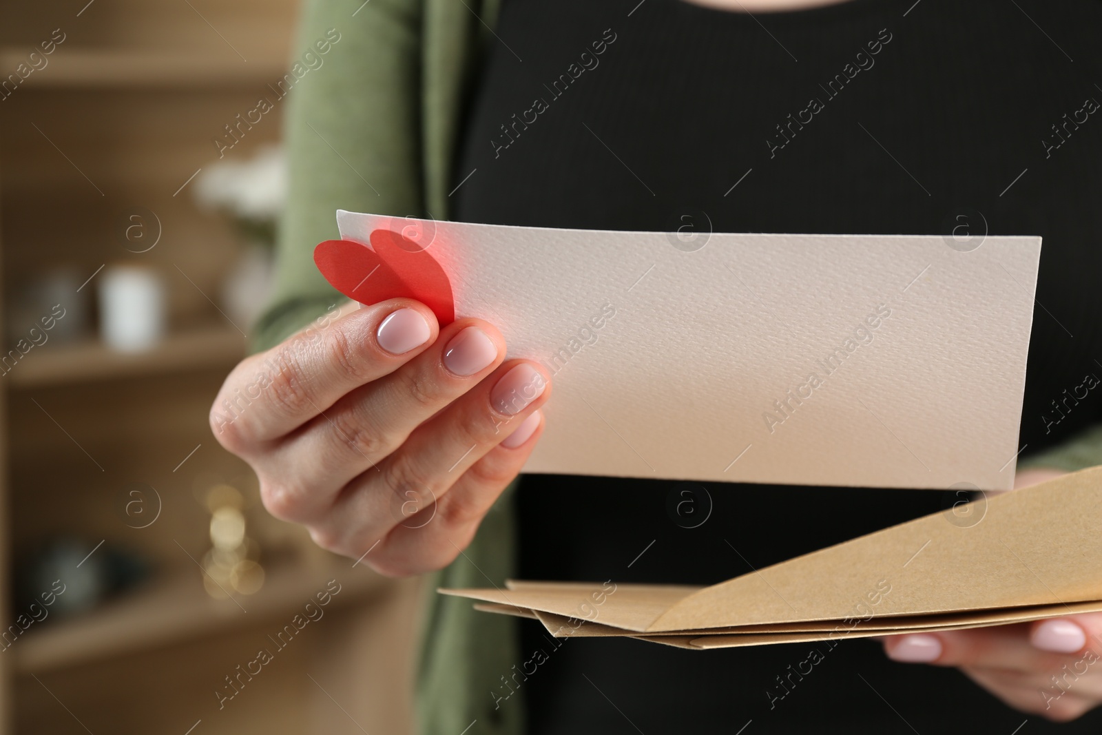 Woman with love letter, envelopes and red heart indoors, closeup Photo of Woman with love letter, envelopes and red heart indoors, closeup