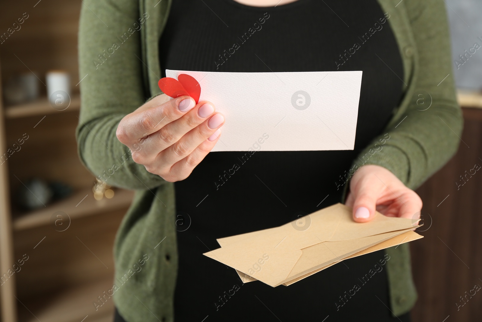 Woman with love letter, envelopes and red heart indoors, closeup Photo of Woman with love letter, envelopes and red heart indoors, closeup