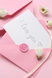 Photo of Stack of letters, card with phrase I Love You and flowers on pink background, above view