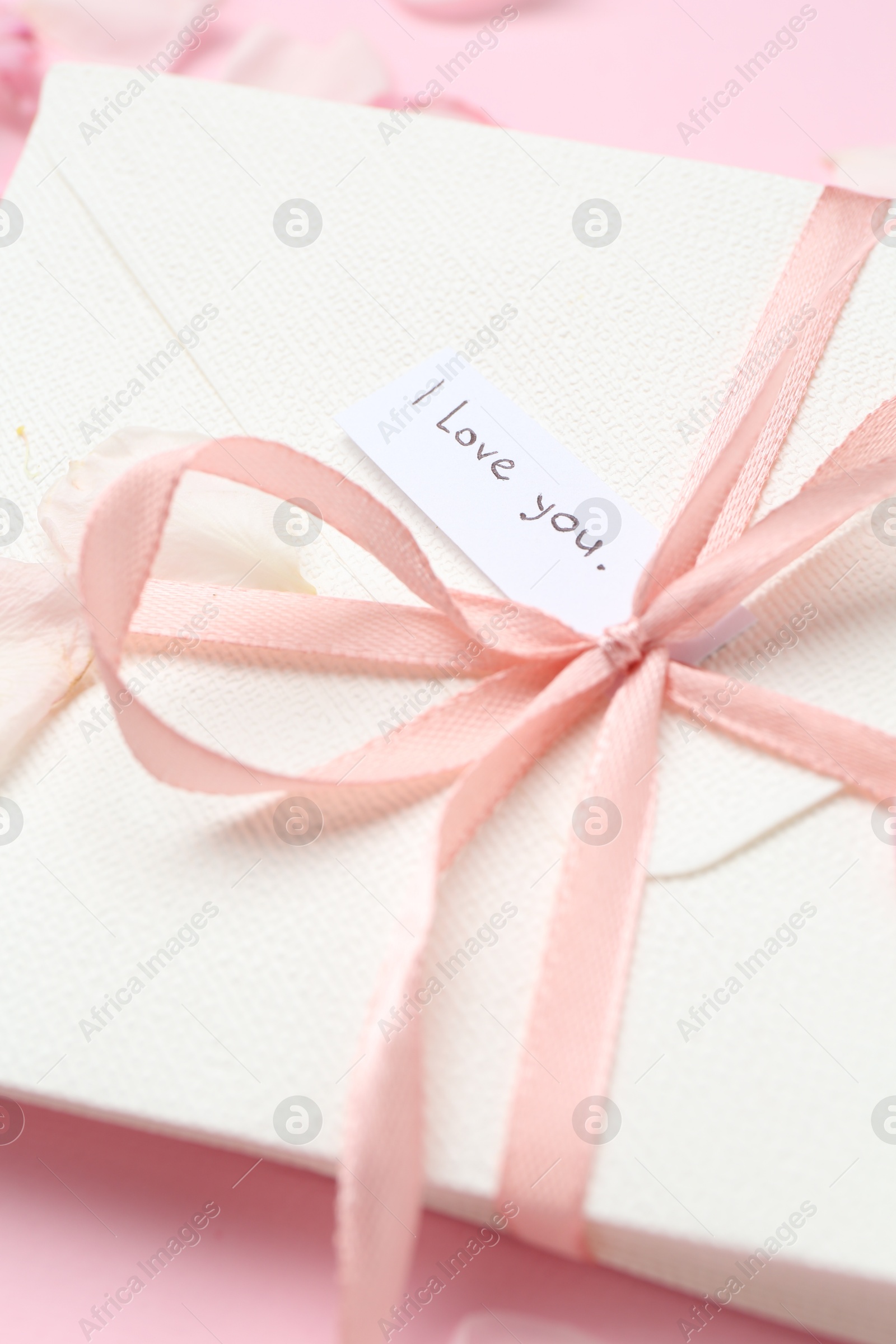 Stack of letters with phrase I Love You on pink background, above view Photo of Stack of letters with phrase I Love You on pink background, above view