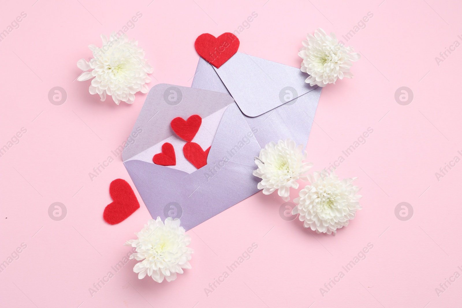 Love letters, flowers and red hearts on pink background, flat lay Photo of Love letters, flowers and red hearts on pink background, flat lay