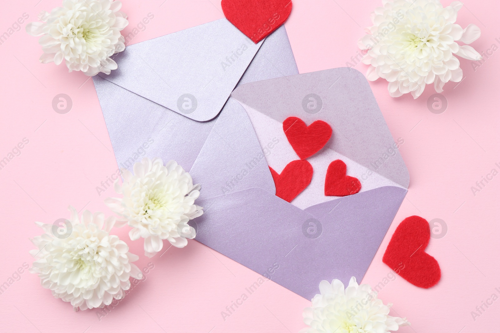 Love letters, flowers and red hearts on pink background, flat lay Photo of Love letters, flowers and red hearts on pink background, flat lay