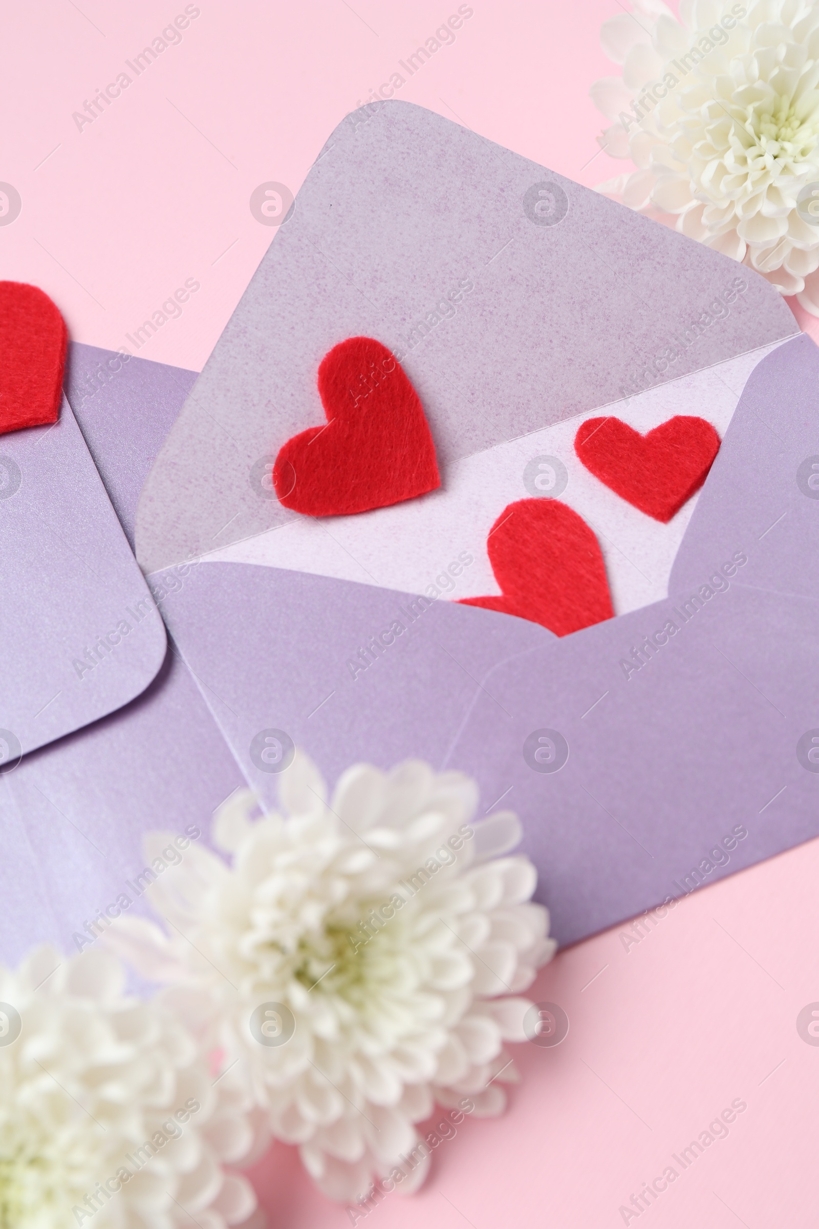 Love letters, flowers and red hearts on pink background, above view Photo of Love letters, flowers and red hearts on pink background, above view