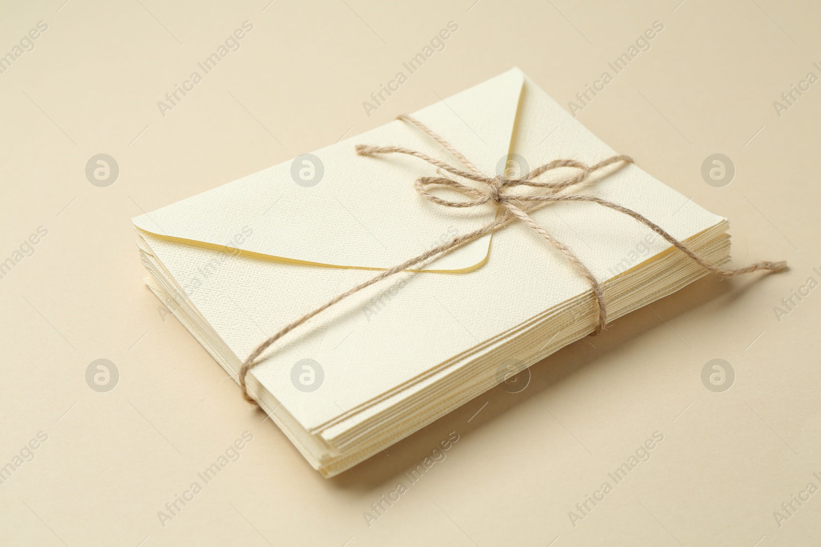 Stack of letters on beige background, closeup Photo of Stack of letters on beige background, closeup