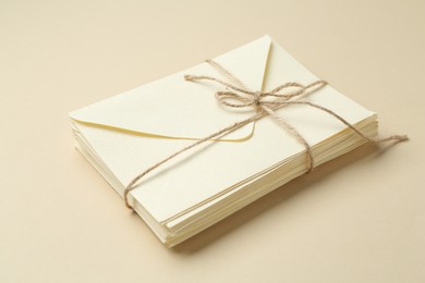 Photo of Stack of letters on beige background, closeup