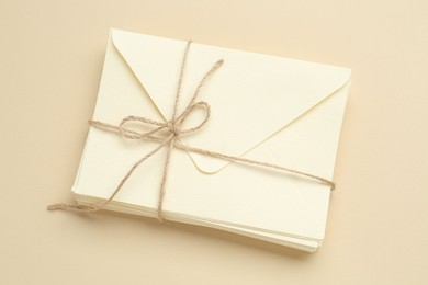 Photo of Stack of letters on beige background, top view