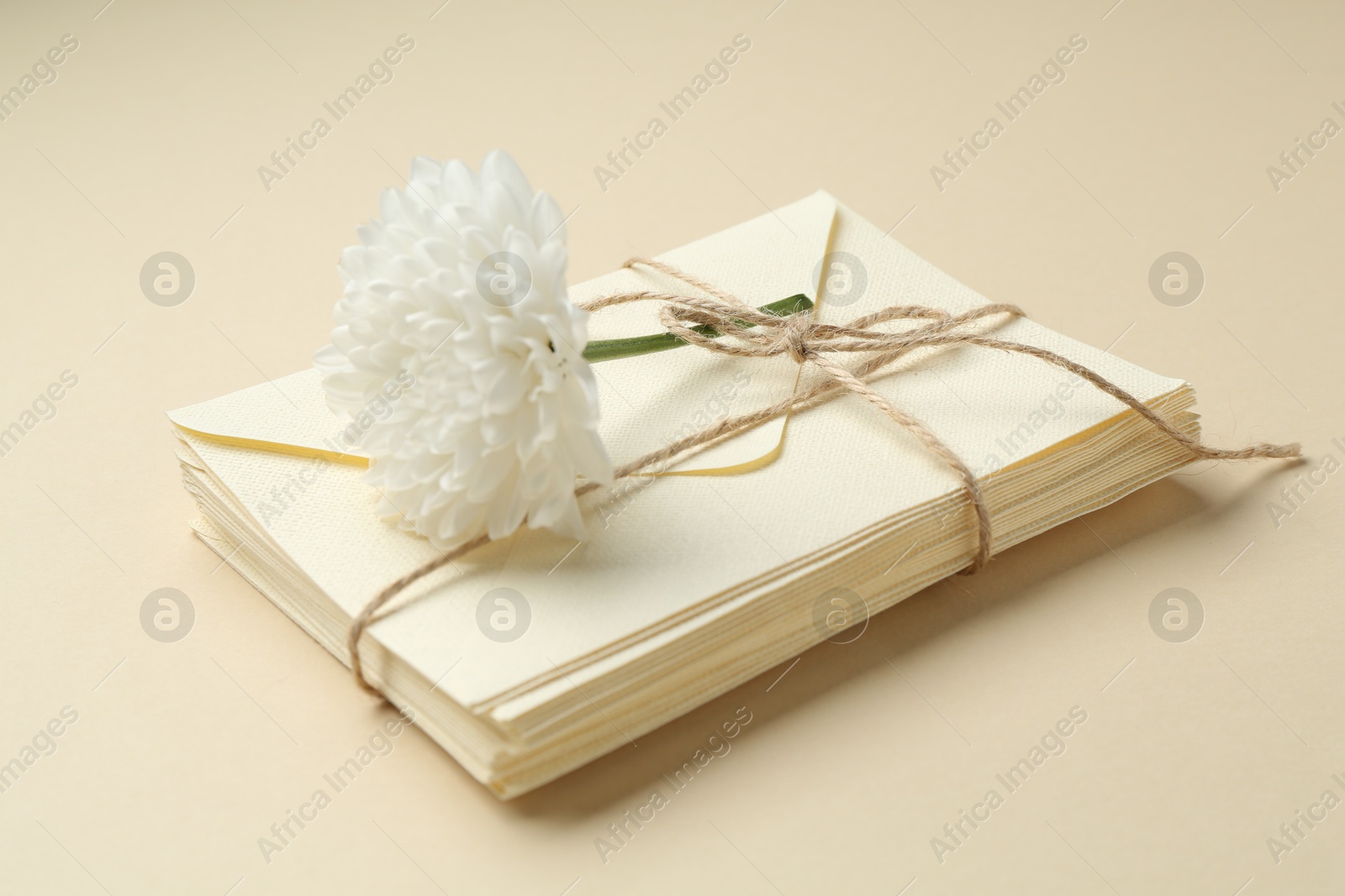 Stack of love letters and flower on beige background, closeup Photo of Stack of love letters and flower on beige background, closeup