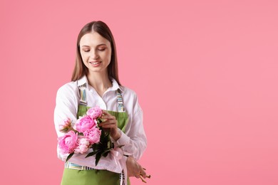 Photo of Florist with beautiful bouquet of peonies on pink background, space for text