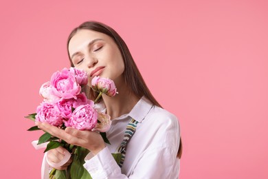 Photo of Florist with beautiful peonies on pink background, space for text