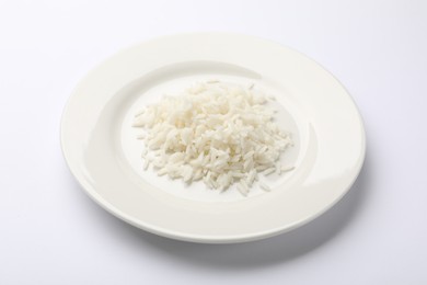 Photo of Pile of rice and plate on white table, closeup