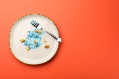 Photo of Dirty plate with crumbs, cream and fork on red table, top view. Space for text