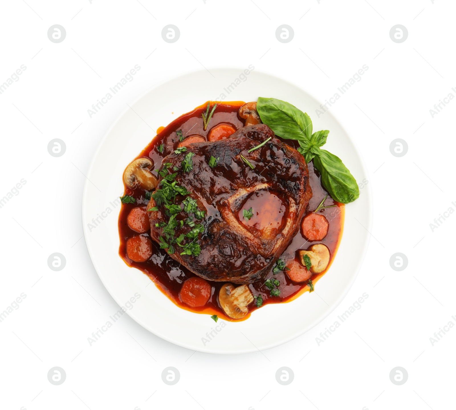 Tasty beef ossobuco with carrot, mushrooms and herbs isolated on white, top view Photo of Tasty beef ossobuco with carrot, mushrooms and herbs isolated on white, top view