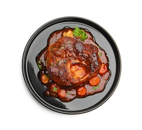 Photo of Tasty beef ossobuco with carrot, parsley and sauce isolated on white, top view
