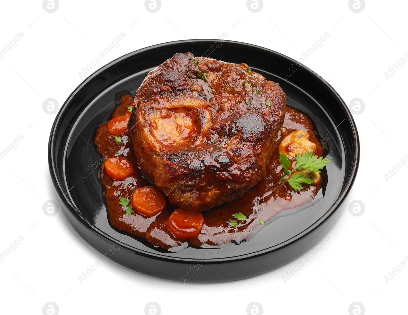 Tasty beef ossobuco with carrot, parsley and sauce isolated on white Photo of Tasty beef ossobuco with carrot, parsley and sauce isolated on white