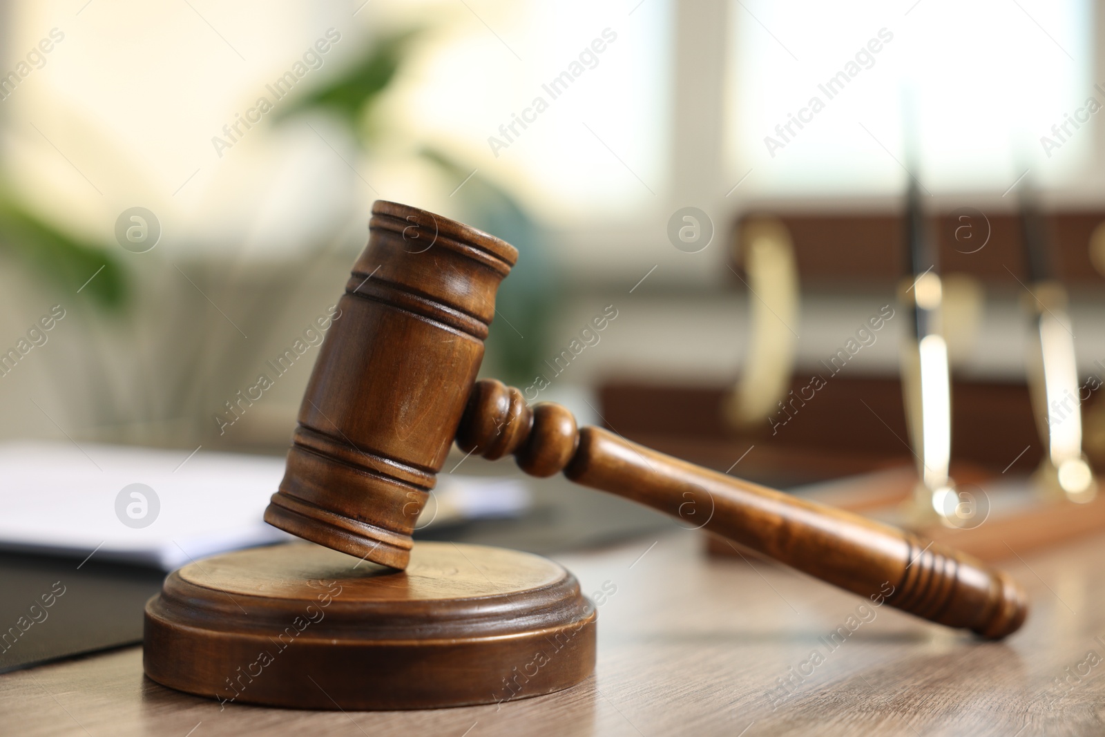 Judge's gavel on wooden table in office, closeup Photo of Judge's gavel on wooden table in office, closeup