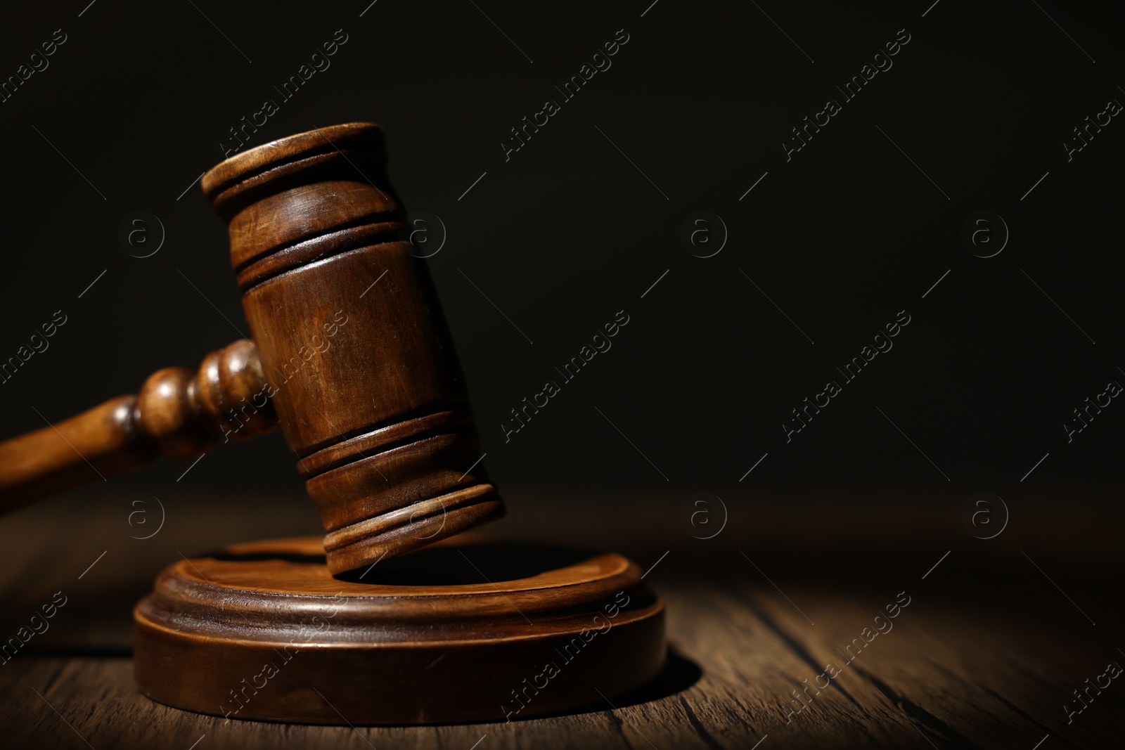 Judge's gavel on wooden table in office, closeup. Space for text Photo of Judge's gavel on wooden table in office, closeup. Space for text