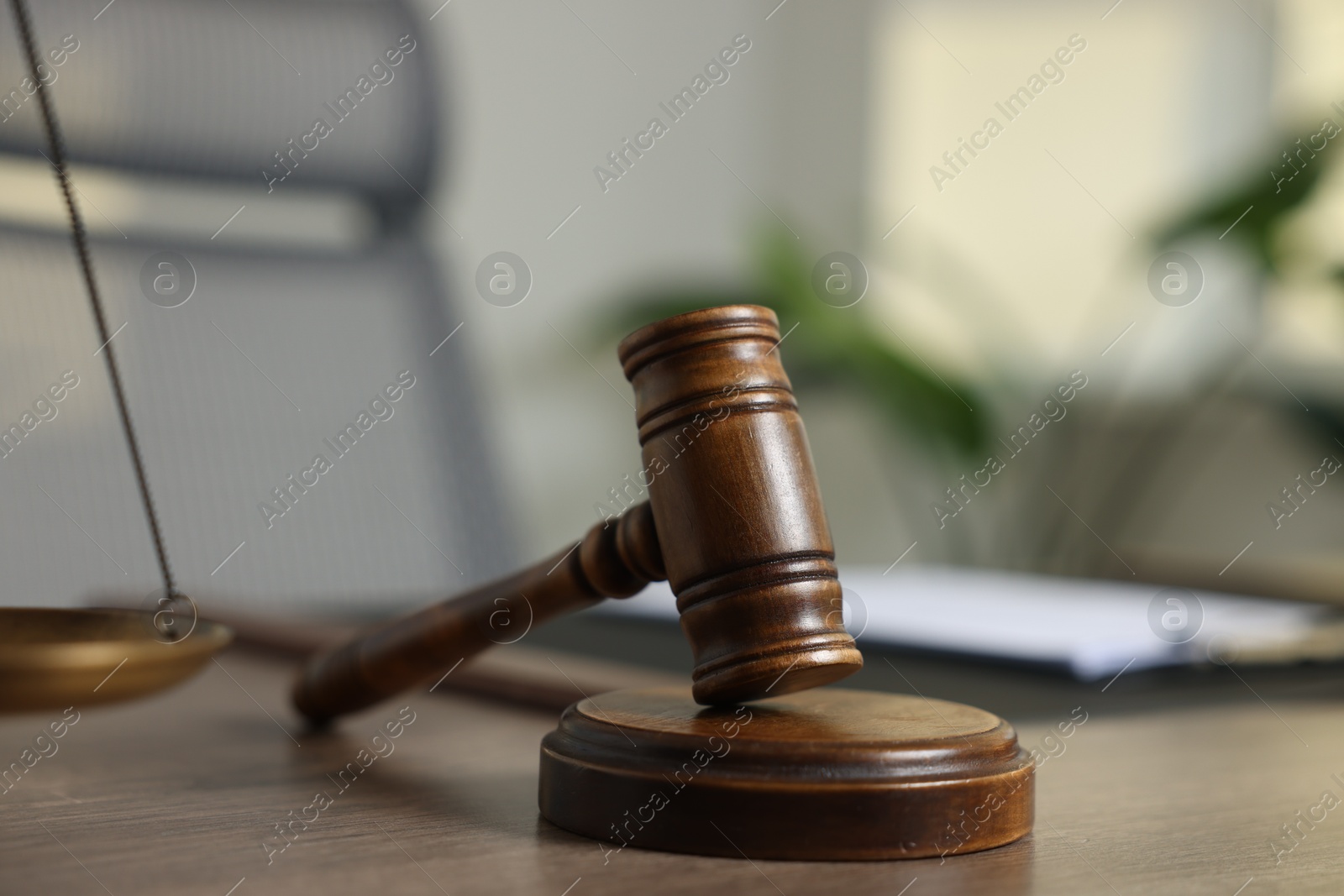 Judge's gavel on wooden table in office, closeup Photo of Judge's gavel on wooden table in office, closeup
