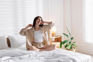 Photo of Woman on bed with soft mattress at home. Space for text