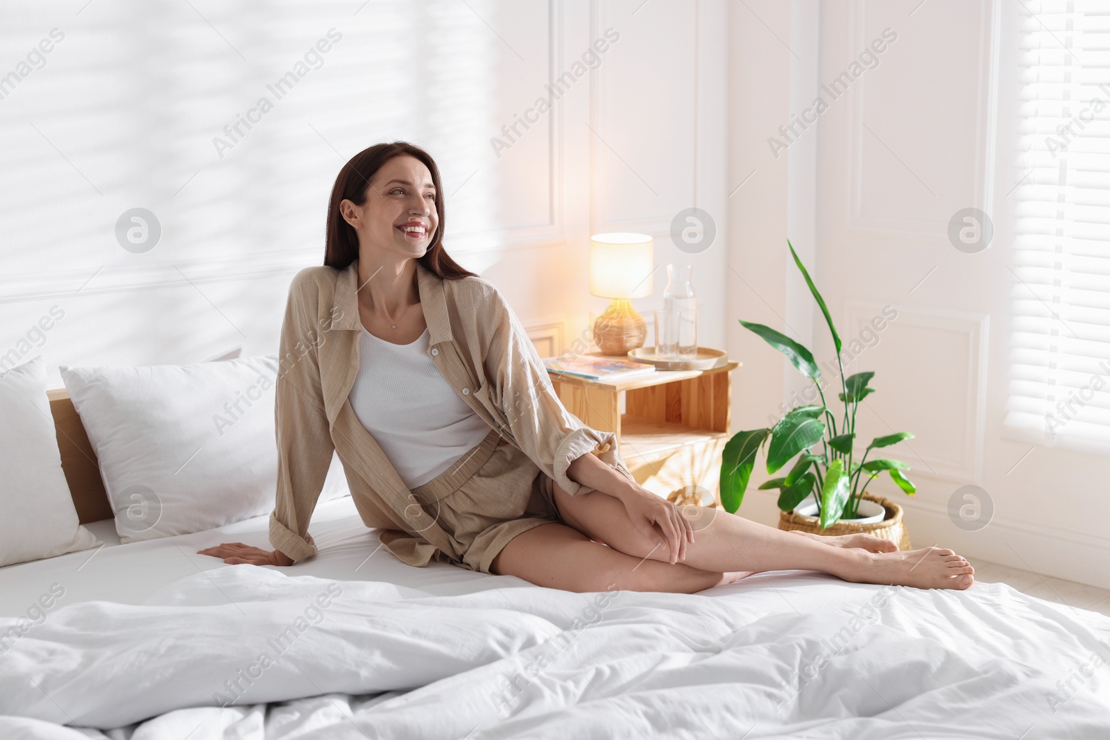 Photo of Woman on bed with soft mattress at home