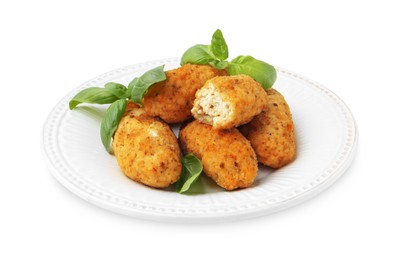 Photo of Tasty fried croquettes and basil isolated on white