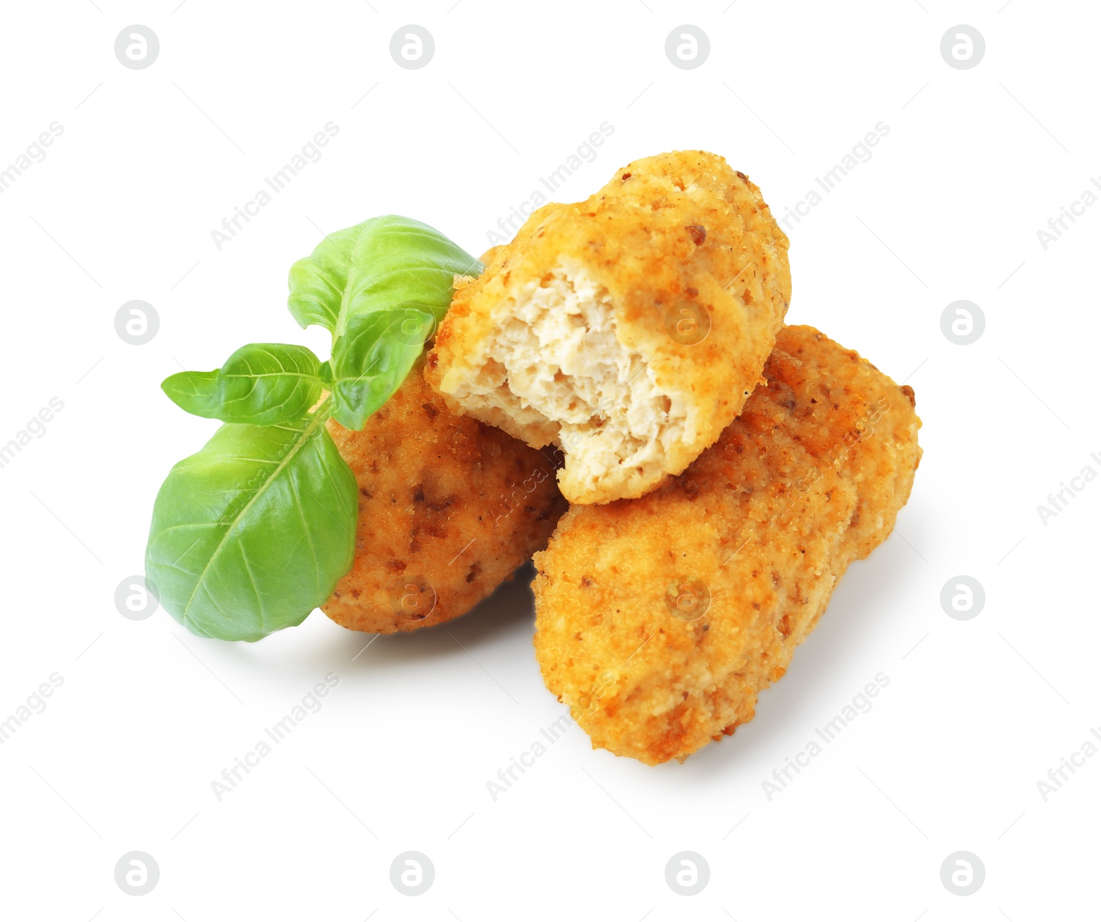 Tasty fried croquettes and basil isolated on white Photo of Tasty fried croquettes and basil isolated on white