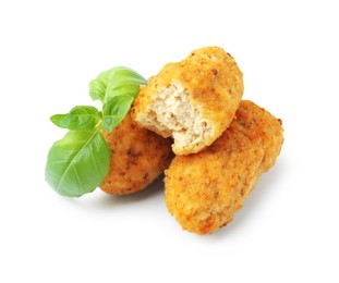 Photo of Tasty fried croquettes and basil isolated on white