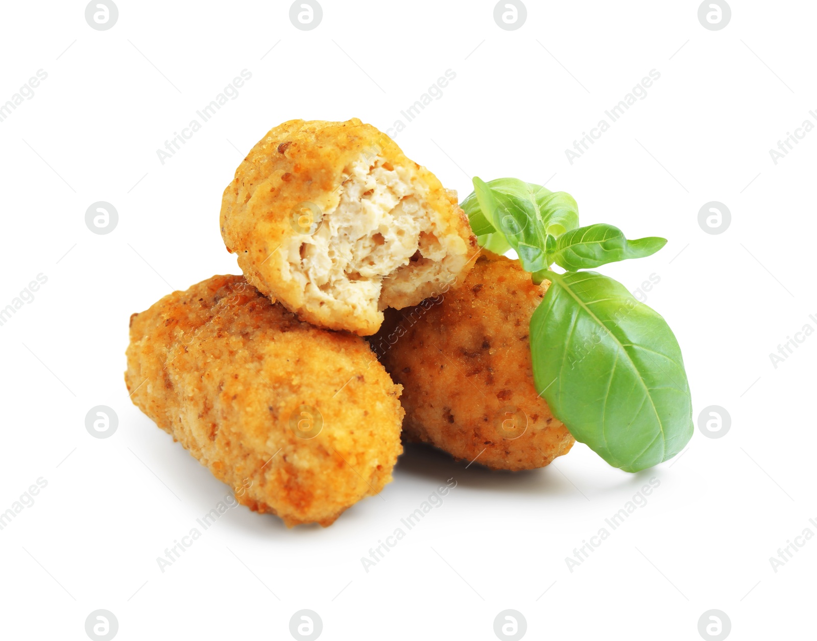Tasty fried croquettes and basil isolated on white Photo of Tasty fried croquettes and basil isolated on white