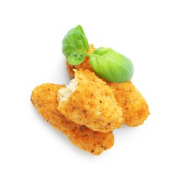 Photo of Tasty fried croquettes and basil isolated on white, top view