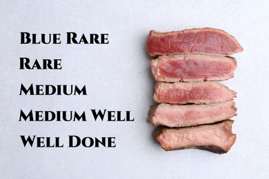 Image of Pieces of delicious beef meat in different degrees of doneness on light table, top view