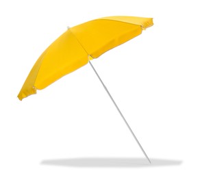 Image of Yellow beach umbrella casting shadow on white background