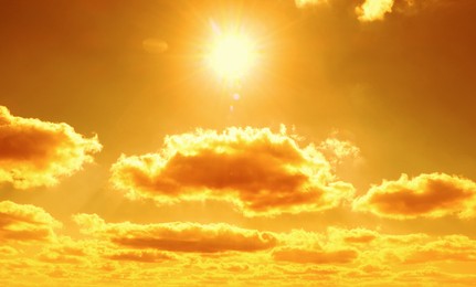 Image of Orange sky with sun and clouds during hot summer weather. Extremely high temperature