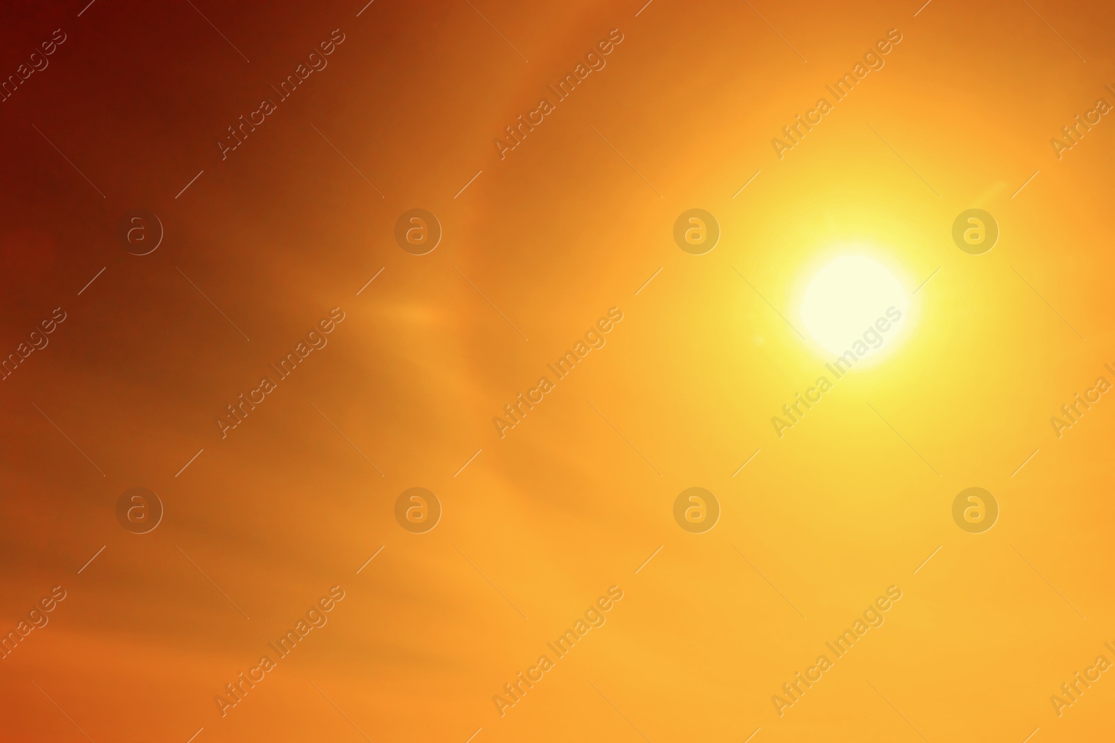 Image of Bright sun in orange sky during hot summer weather. Extremely high temperature