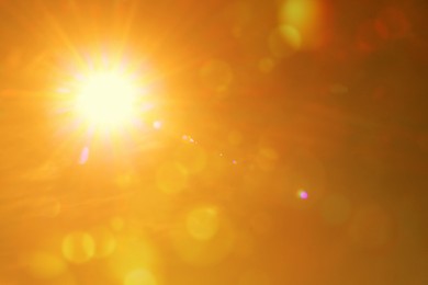 Image of Bright sun in orange sky during hot summer weather. Extremely high temperature