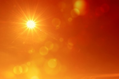 Image of Bright sun in orange sky during hot summer weather. Extremely high temperature