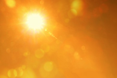 Image of Bright sun in orange sky during hot summer weather. Extremely high temperature