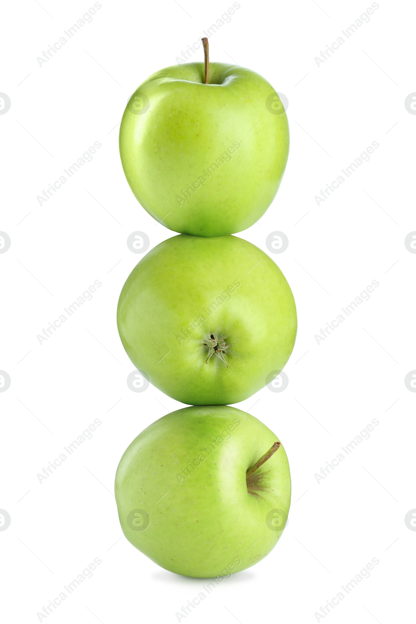 Image of Green apples stacked on top of each other against white background. Balance