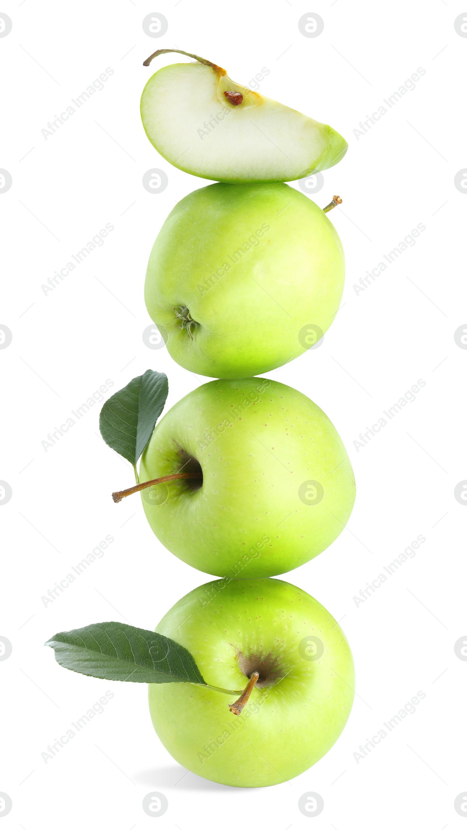 Green apples stacked on top of each other against white background. Balance Image of Green apples stacked on top of each other against white background. Balance