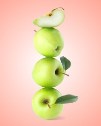 Image of Green apples stacked on top of each other against pink gradient background. Balance