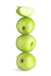 Image of Green apples stacked on top of each other against white background. Balance