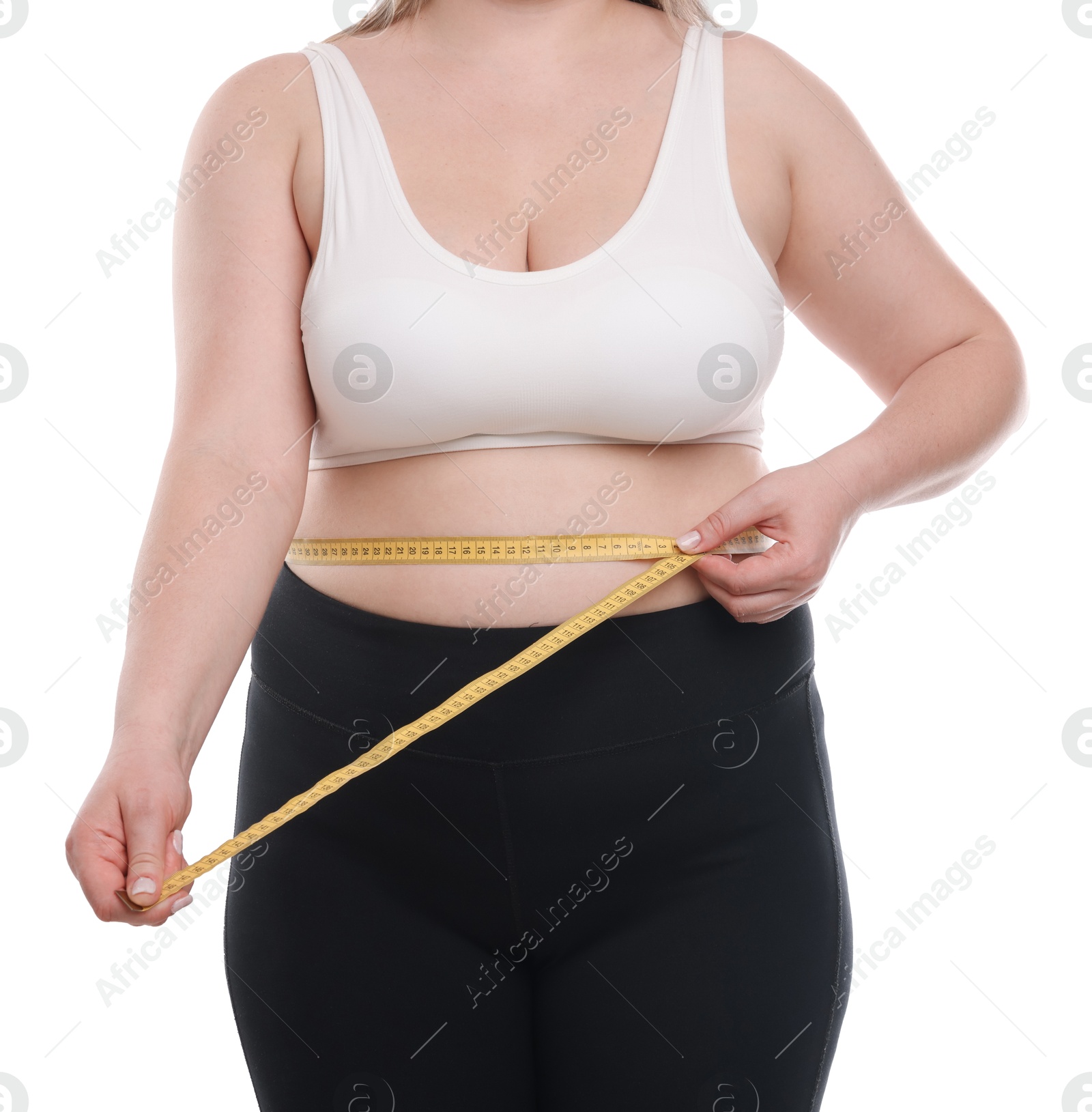 Weight loss. Plus size woman measuring waist with tape on white background, closeup Photo of Weight loss. Plus size woman measuring waist with tape on white background, closeup