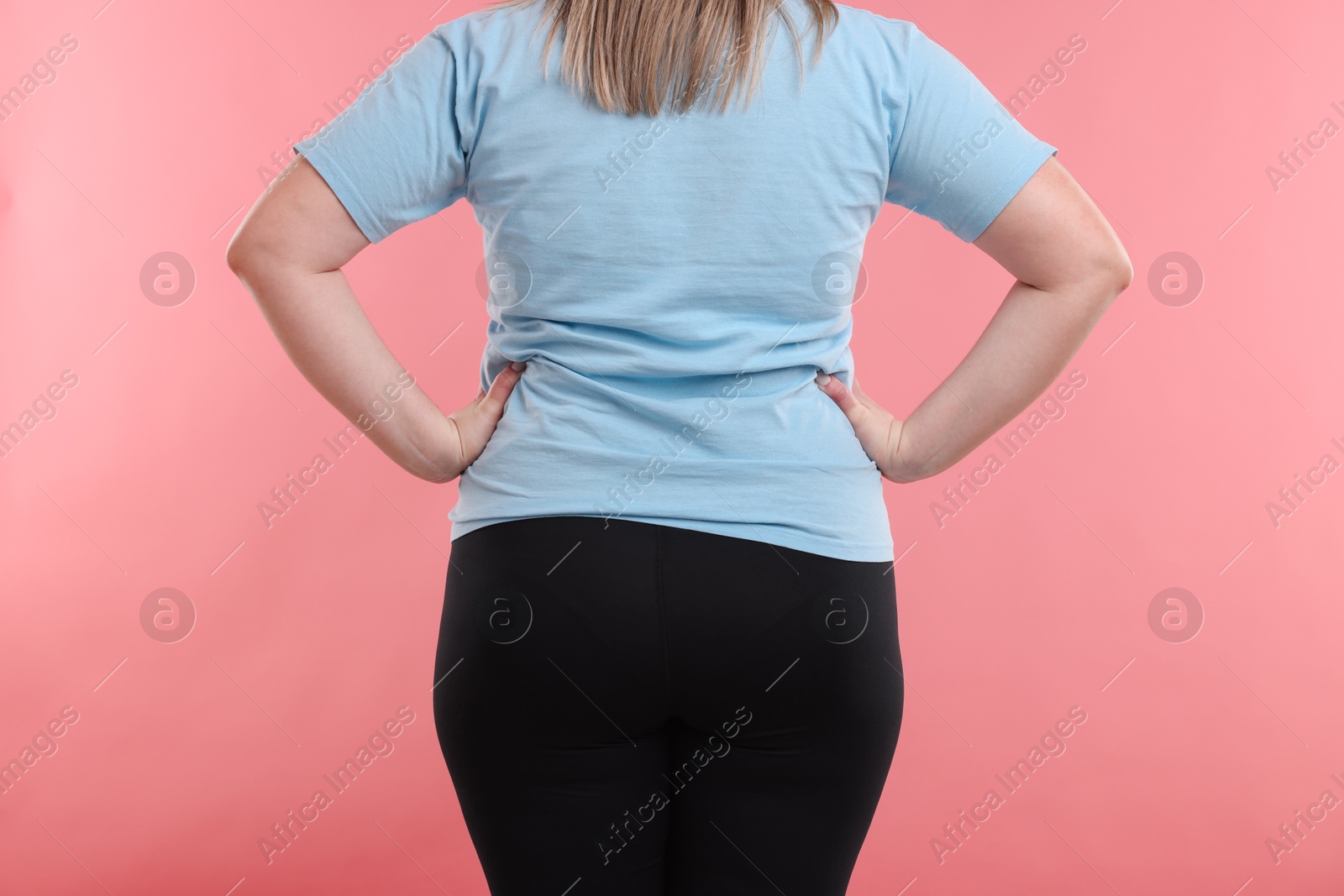 Weight loss. Plus size woman on pink background, closeup Photo of Weight loss. Plus size woman on pink background, closeup
